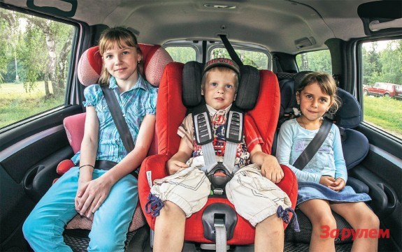 Трое детей в детских креслах в машине